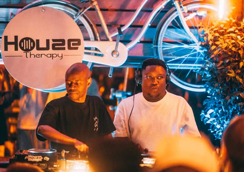 DJs on the decks under the Houze Therapy sign