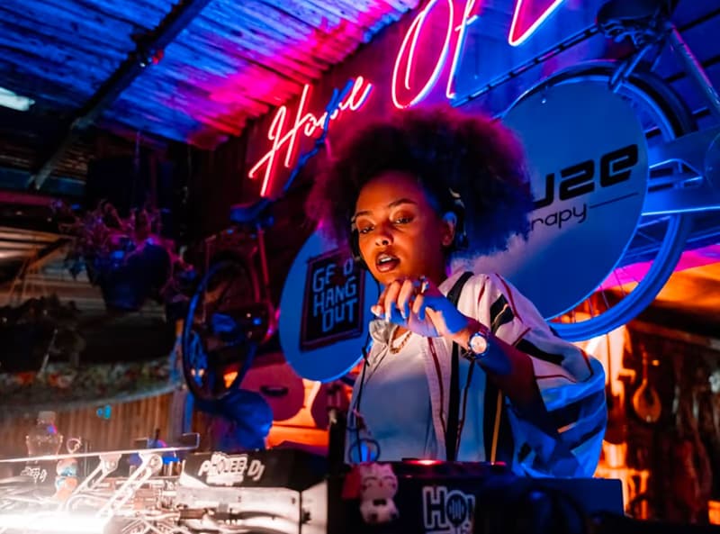 A DJ performing under neon lights