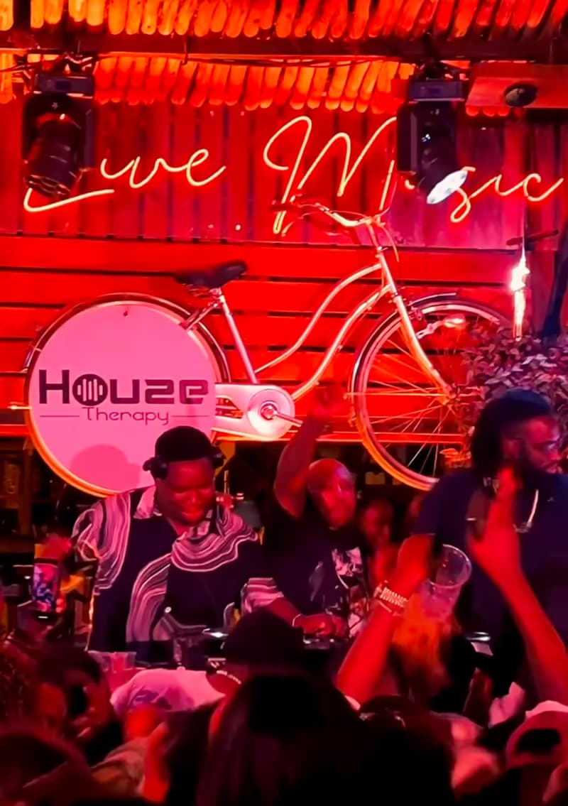 A crowd under the Live Music neon sign