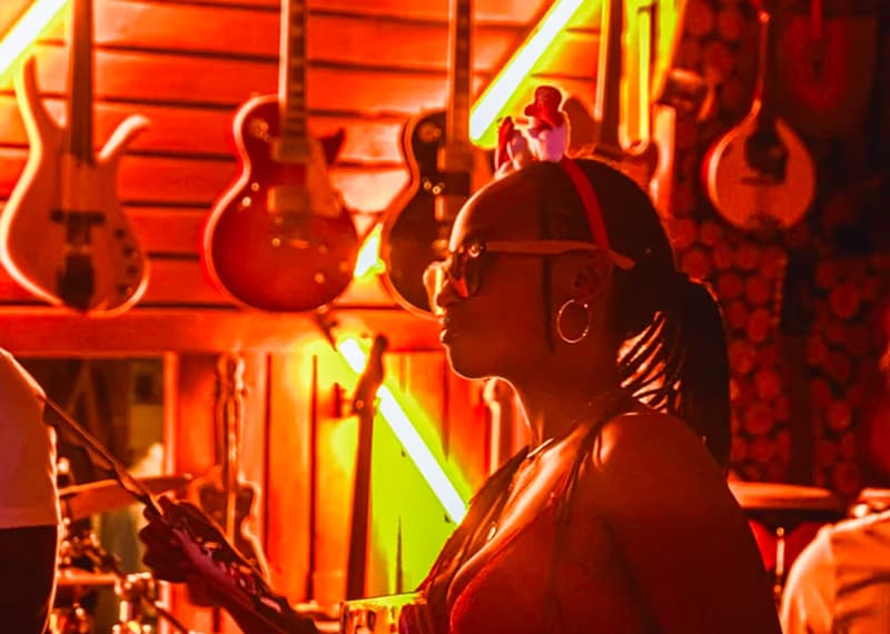 A musician performing in red stage light