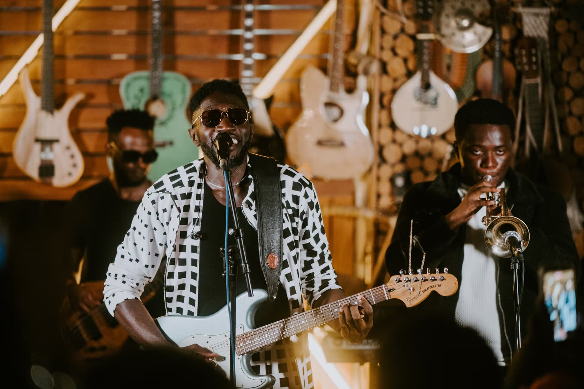 A guitarist and trumpeter playing live