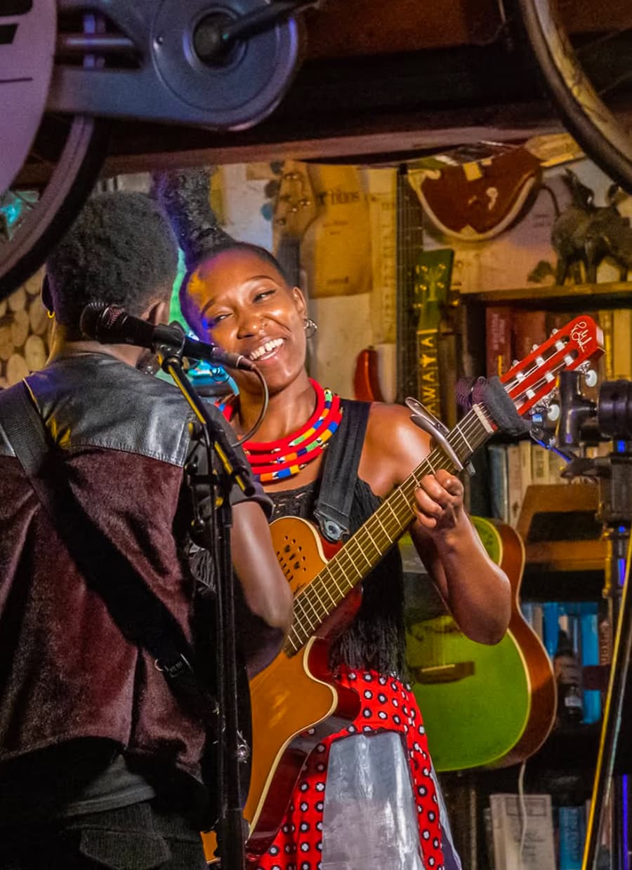 A singer playing guitar on stage