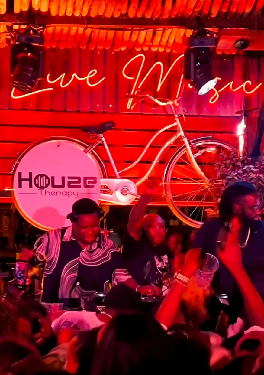 A crowd under the Live Music neon sign